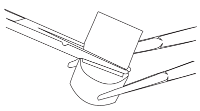 Using folded lens tissue as a small cleaning brush.